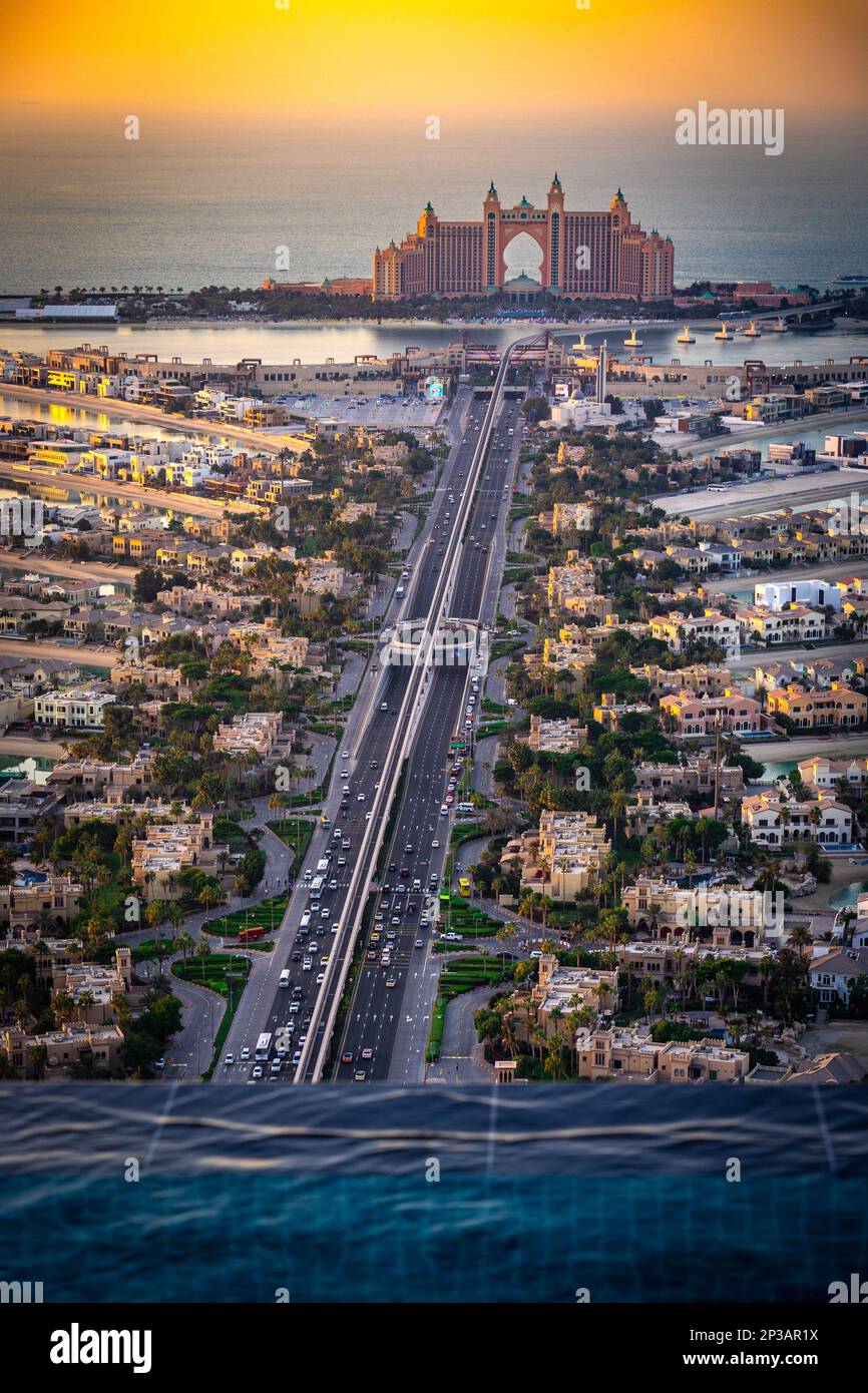 Panoramic sunset view of Palm Jumeirah with the Atlantis Hotel in the distance, shot from the edge of Aura Skypool - an infinite pool 50 floors Stock Photo