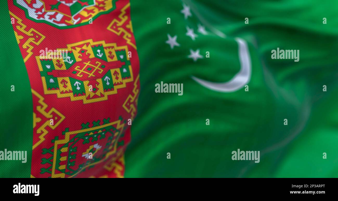 Detail of the Turkmenistan national flag waving. Green field, red vertical band, crescent moon, five stars, carpet motifs. 3d illustration render. Sel Stock Photo