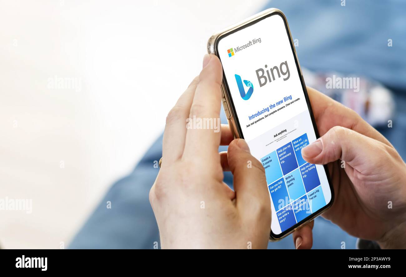 Redmond, US, Feb 2023: Female hands holding a phone with the Microsoft Bing website on the screen. Interior shot. Bing is a search engine recently int Stock Photo