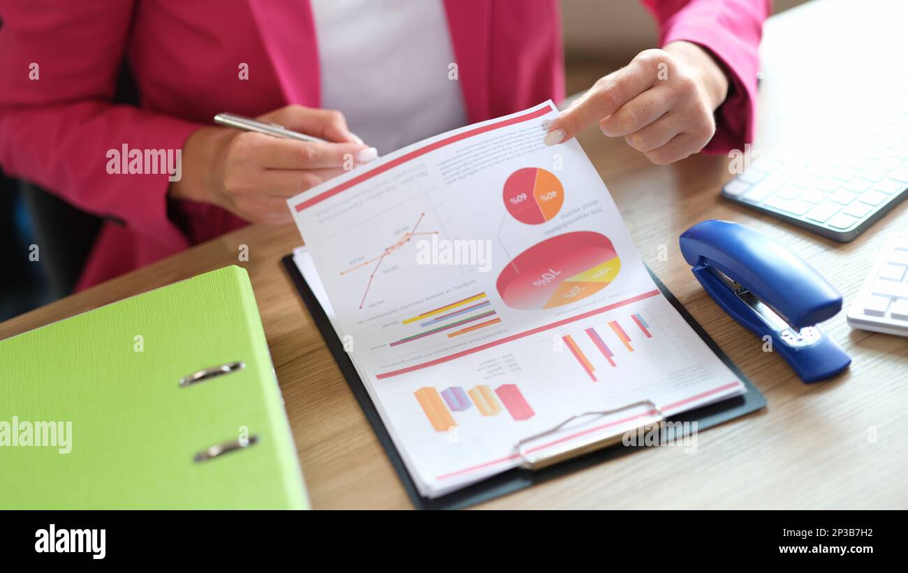Manager working with financial reports while sitting at table in office. Stock Photo