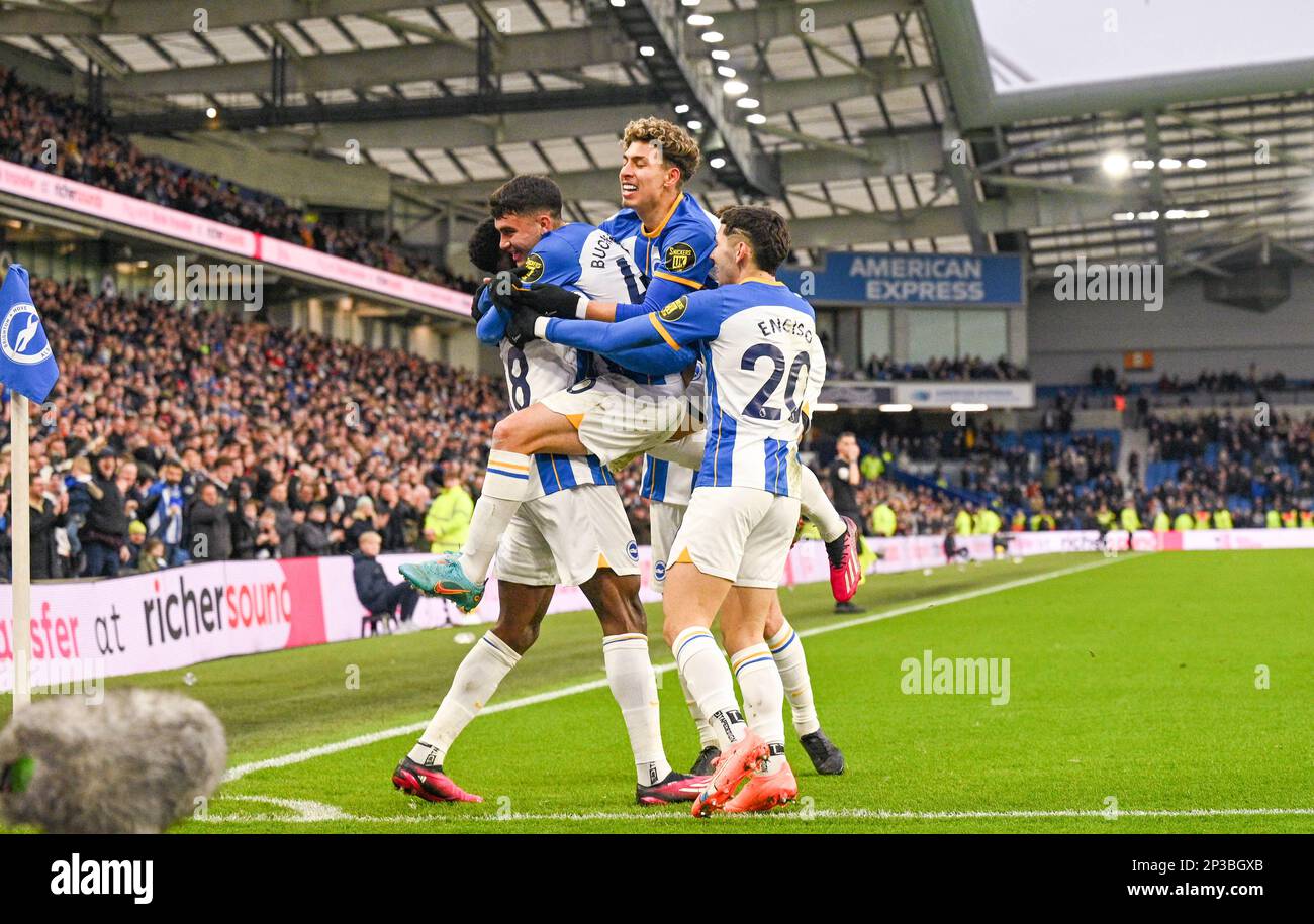 The Brighton players leap on Danny Welbeck after he had scored  their fourth goal during the Premier League match between Brighton & Hove Albion and West Ham United at The American Express Community Stadium , Brighton , UK - 4th March 2023 Photo Simon Dack/Telephoto Images.   Editorial use only. No merchandising. For Football images FA and Premier League restrictions apply inc. no internet/mobile usage without FAPL license - for details contact Football Dataco Stock Photo