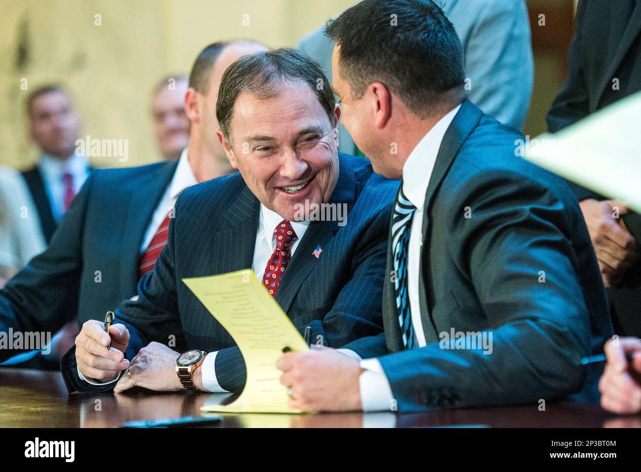 Gov. Gary R. Herbert smiles as he and House Speaker Greg Hughes sign