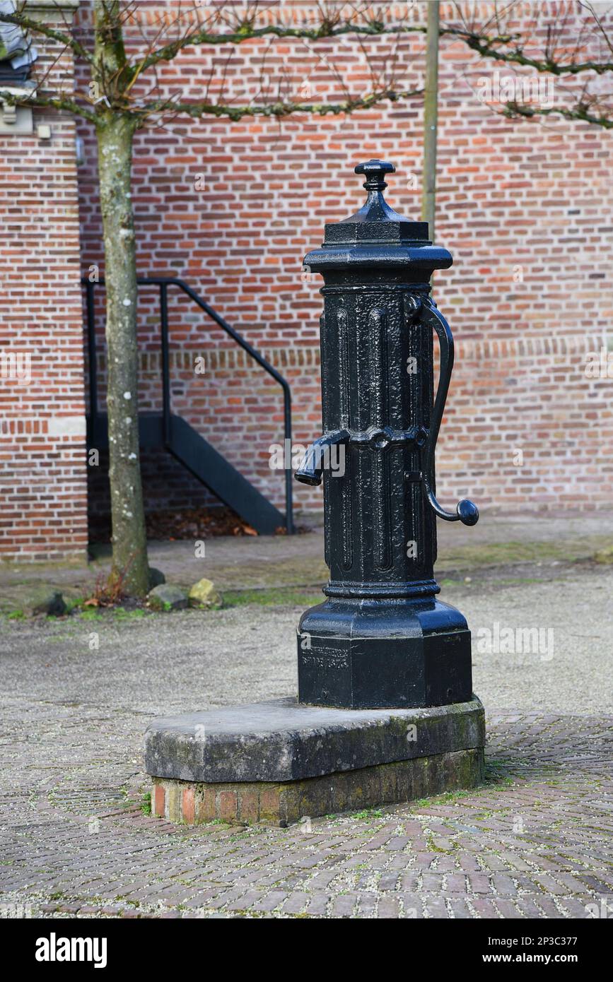 Broek in Waterland, Netherlands. February 2023. Old water pump on the Kerkplein in Broek in Waterland, Netherlands. High quality photo Stock Photo