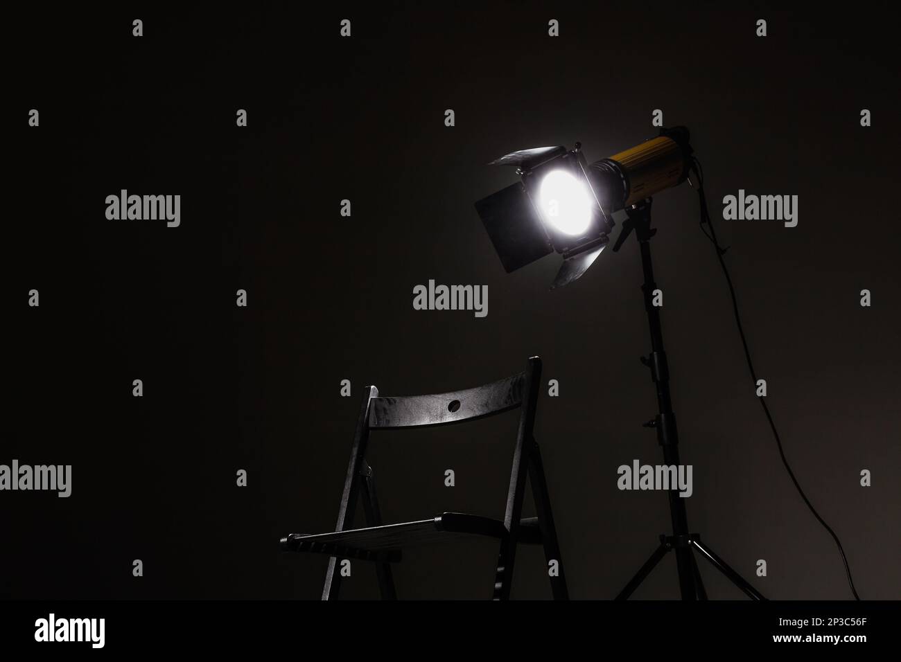 Movie directors chair on set with light on a stand. Stock Photo