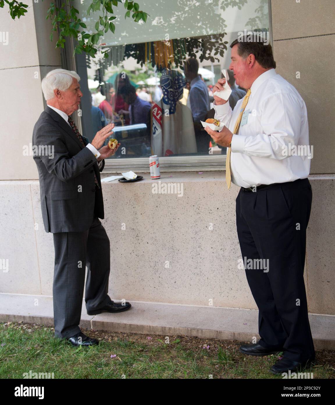 UNITED STATES - JULY 18: Reps. Jerry Lewis, R-Calif., left, and Ken Calvert, R-Calif., eat hot dogs at the American Meat Institute's Annual Hot Dog Lunch in Rayburn courtyard to mark July as National Hot Dog Month. (Photo By Tom Williams/CQ Roll Call) (CQ Roll Call via AP Images) Stock Photo