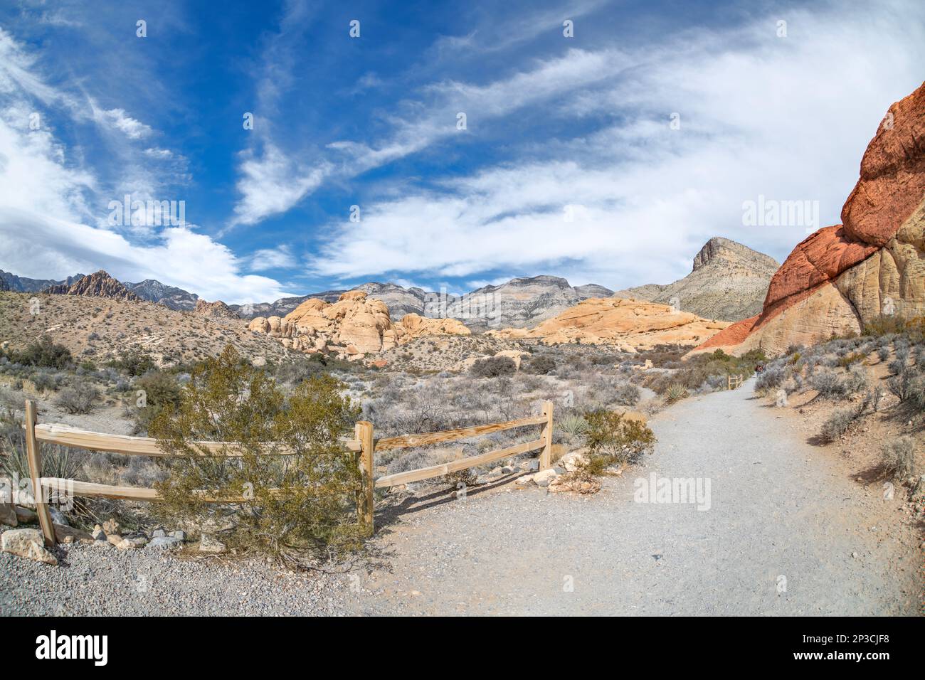 Hiking trail leading into the deep heart of Red Rock Canyon in Las Vegas shows a vibrant day to be active and enjoy leisure time. Stock Photo
