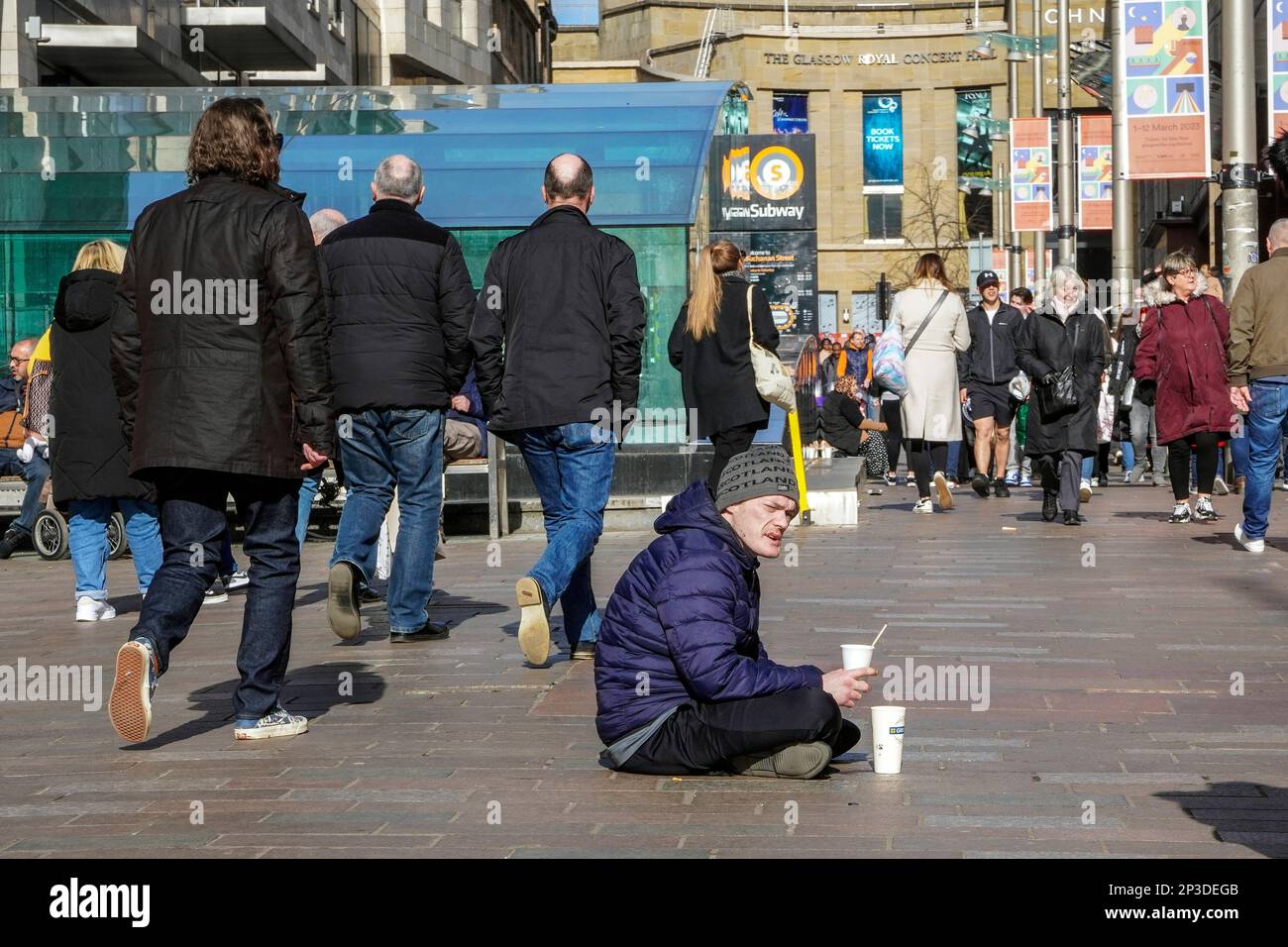 Street beggar sitting in Buchanan Street pedestrain precinct, Glasgow, Scotland, UK Stock Photo