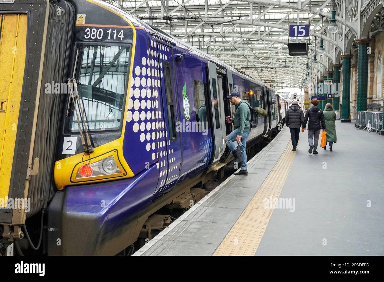 Passengers on the platform with a Scotrail train at Glasgow Central
