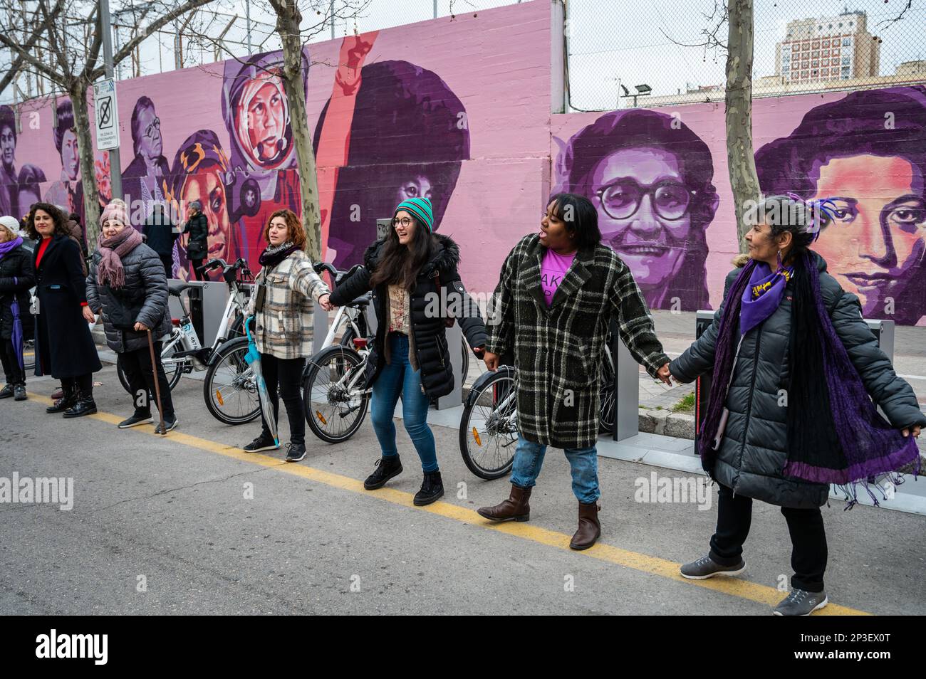 Madrid, Spain. 05th Mar, 2023. Women standing in front of a feminist mural are seen during a human chain to denounce violence against women and make visible the feminist struggle as part of the activities for International Women's Day. In the mural appear the faces of 15 women who are part of history for their fight in favor of equality such as Angela Davis, Frida Kahlo, Nina Simone, among others. Credit: Marcos del Mazo/Alamy Live News Stock Photo