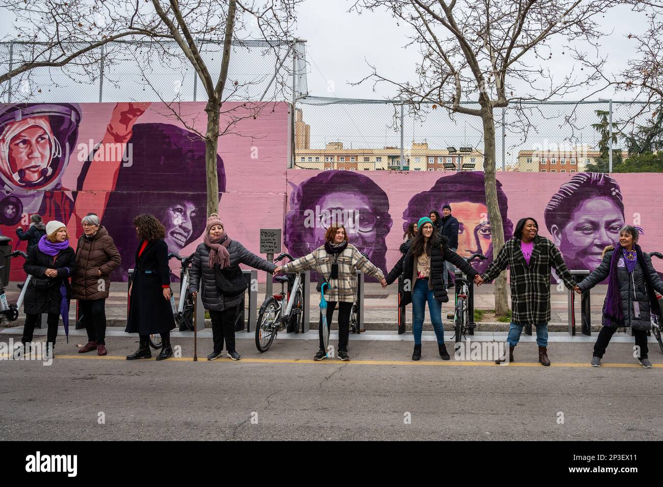 Madrid, Spain. 05th Mar, 2023. Women standing in front of a feminist mural are seen during a human chain to denounce violence against women and make visible the feminist struggle as part of the activities for International Women's Day. In the mural appear the faces of 15 women who are part of history for their fight in favor of equality such as Angela Davis, Frida Kahlo, Nina Simone, among others. Credit: Marcos del Mazo/Alamy Live News Stock Photo