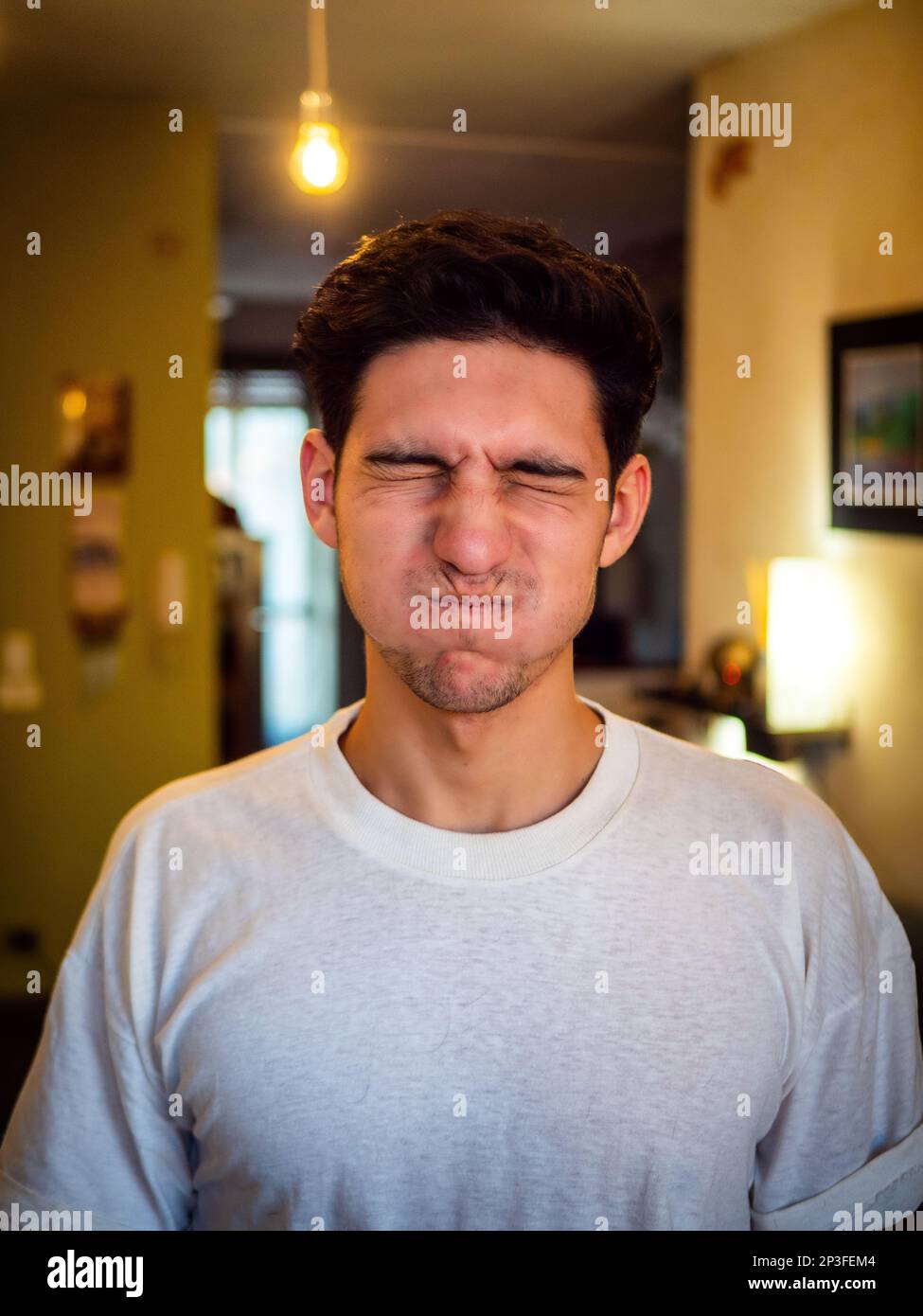 Young man with puffed cheeks, holding breath Stock Photo Alamy