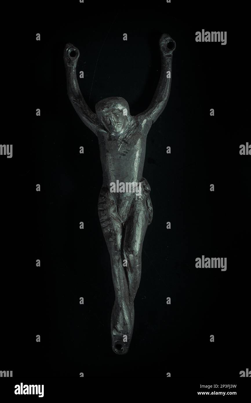 christian crucifix and rosary beads on abstract grey background