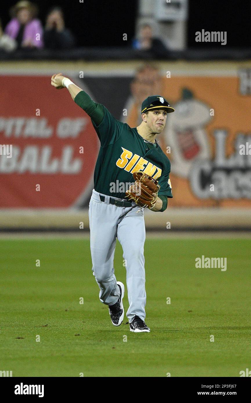 Siena Saints outfielder Alex Tuccio (20) throws the ball in during the  opening game of the season against the UCF Knights on February 13, 2015 at  Jay Bergman Field in Orlando, Florida.