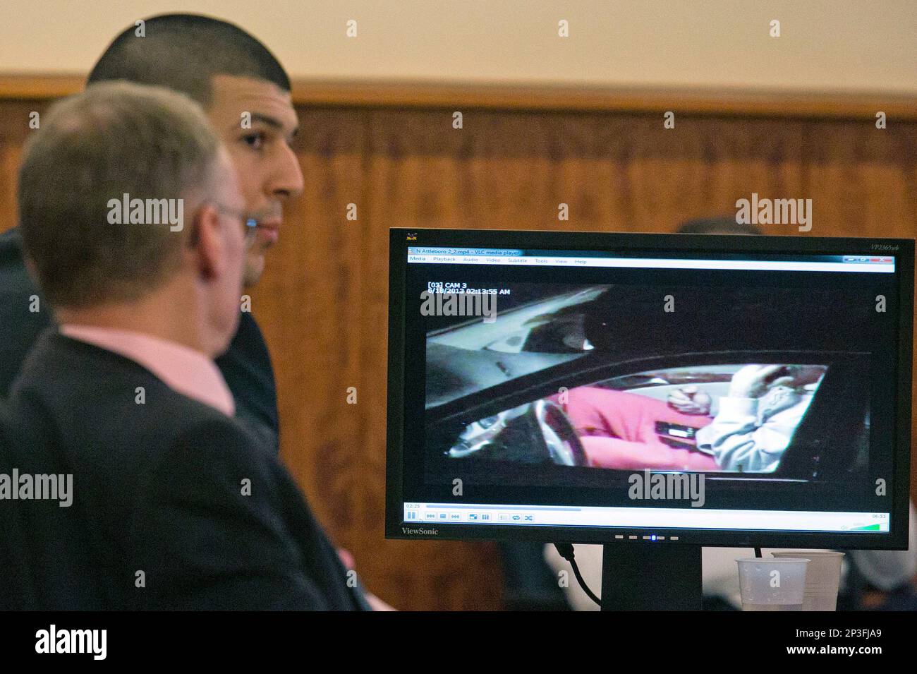Aaron Hernandez, rear, and his attorney Charles Rankin watch