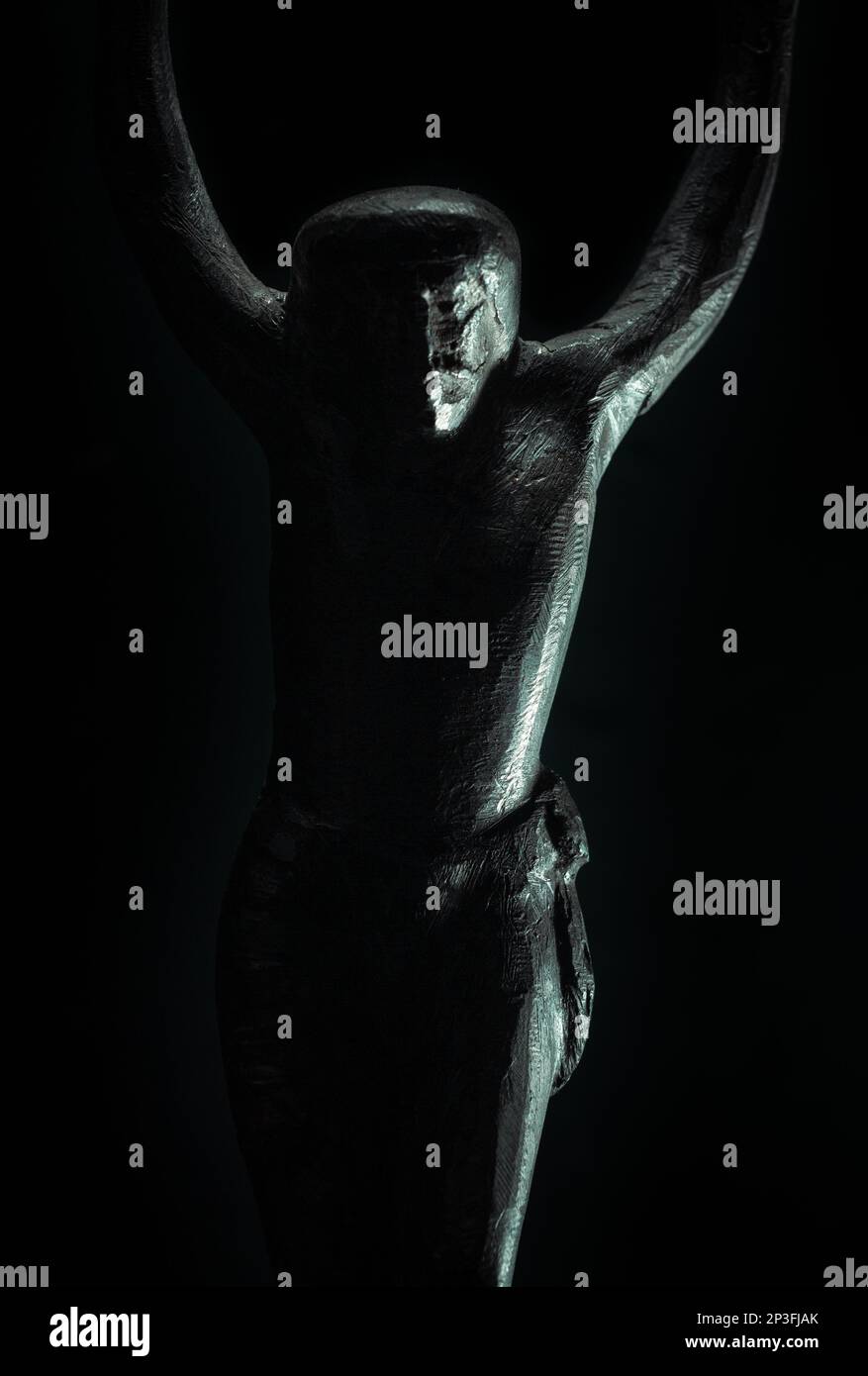 christian crucifix and rosary beads on abstract grey background