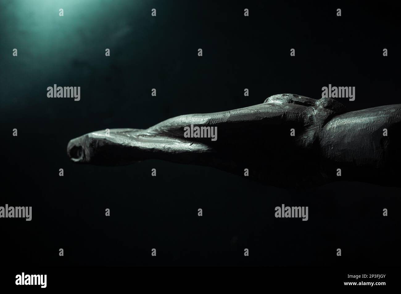 christian crucifix and rosary beads on abstract grey background