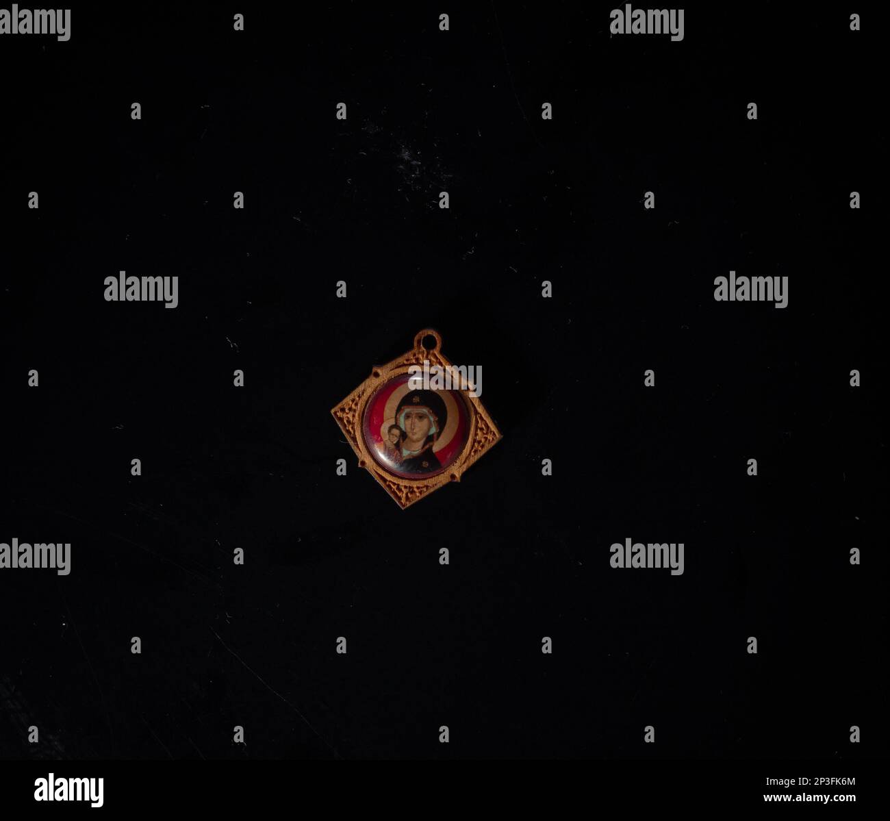 christian crucifix and rosary beads on abstract grey background