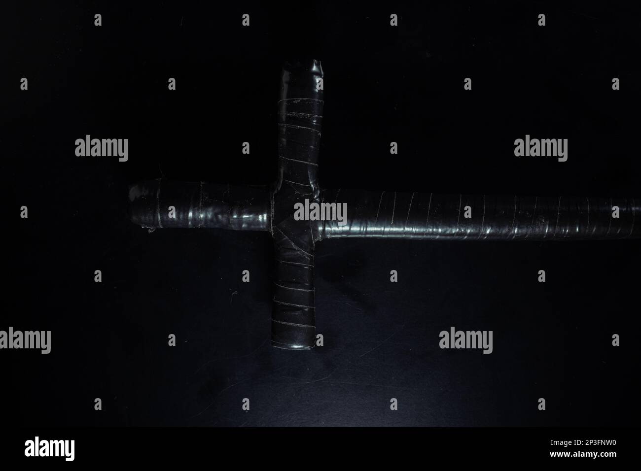 christian crucifix and rosary beads on abstract grey background