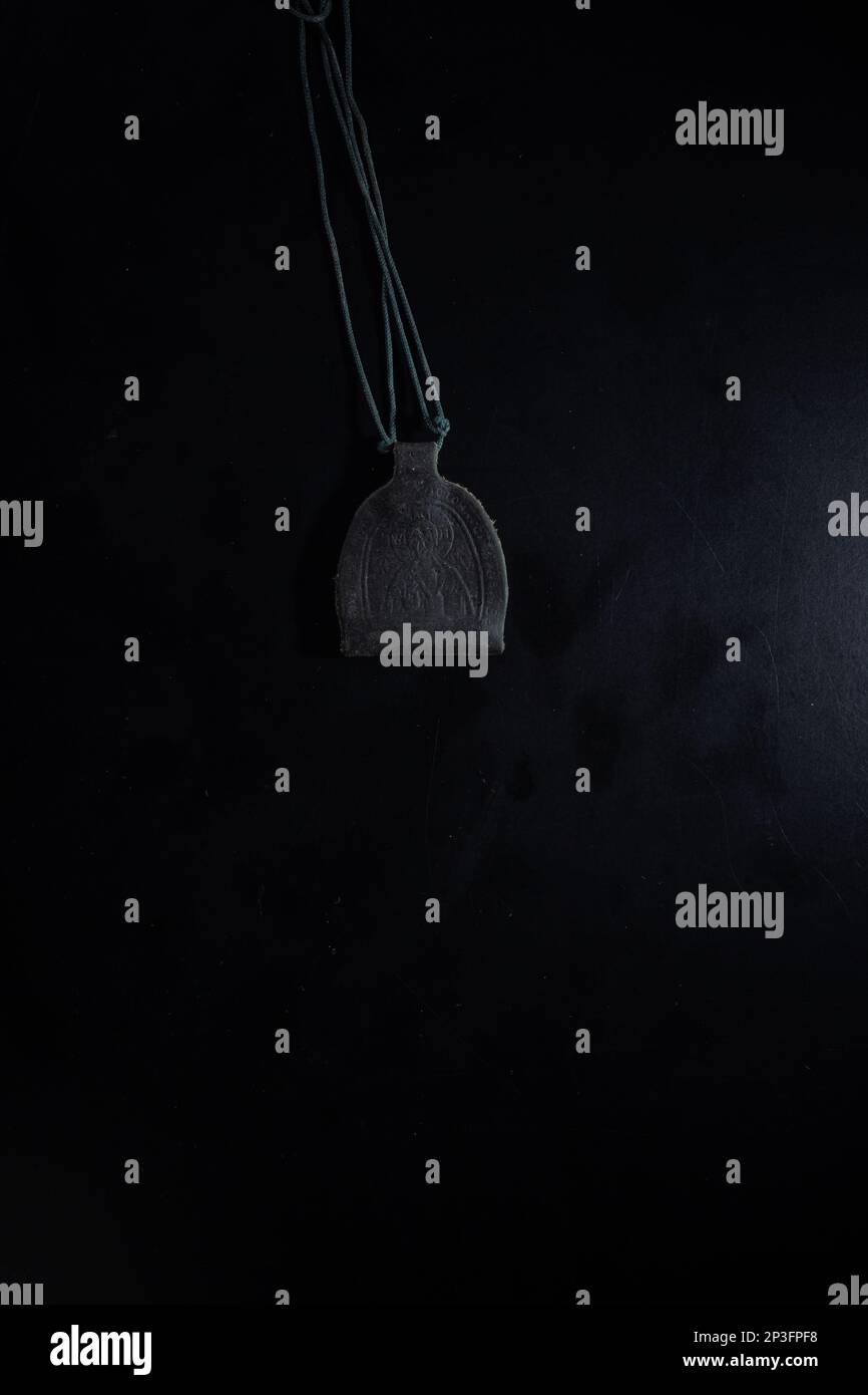 christian crucifix and rosary beads on abstract grey background