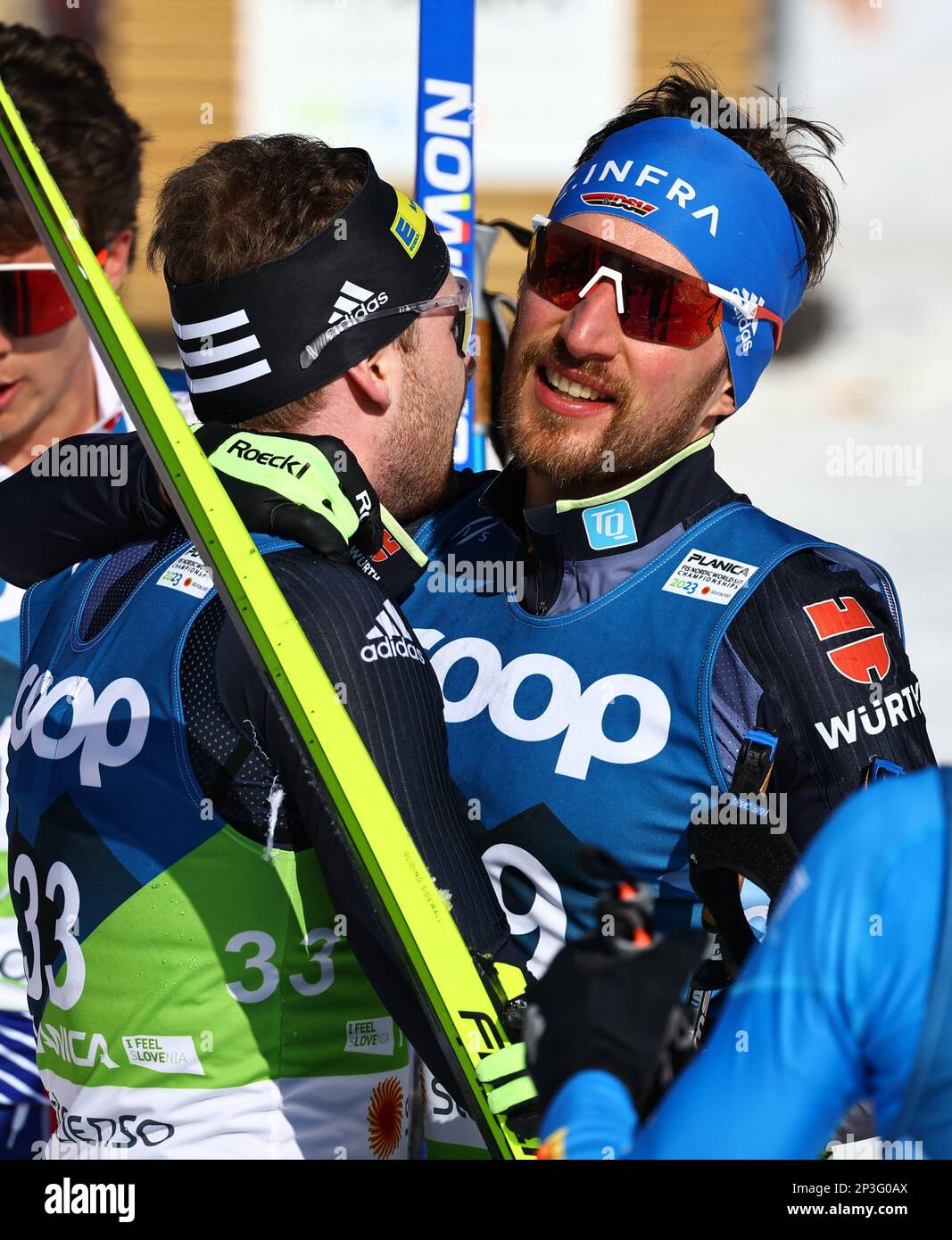 Planica, Slovenia. 05th Mar, 2023. Nordic skiing: World Championship, cross-country skiing - 50 km classic, men. The two Germans, Albert Kuchler (l) and Jonas Dobler, hug each other after reaching the finish line. Credit: Daniel Karmann/dpa/Alamy Live News Stock Photo