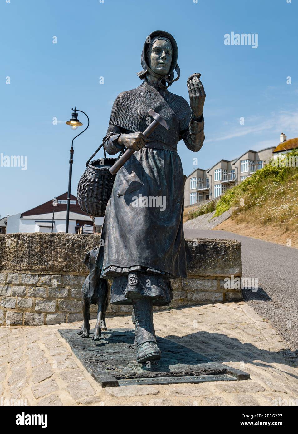 Bronze sculpture of geologist Mary Anning holding a fossil on Jurassic