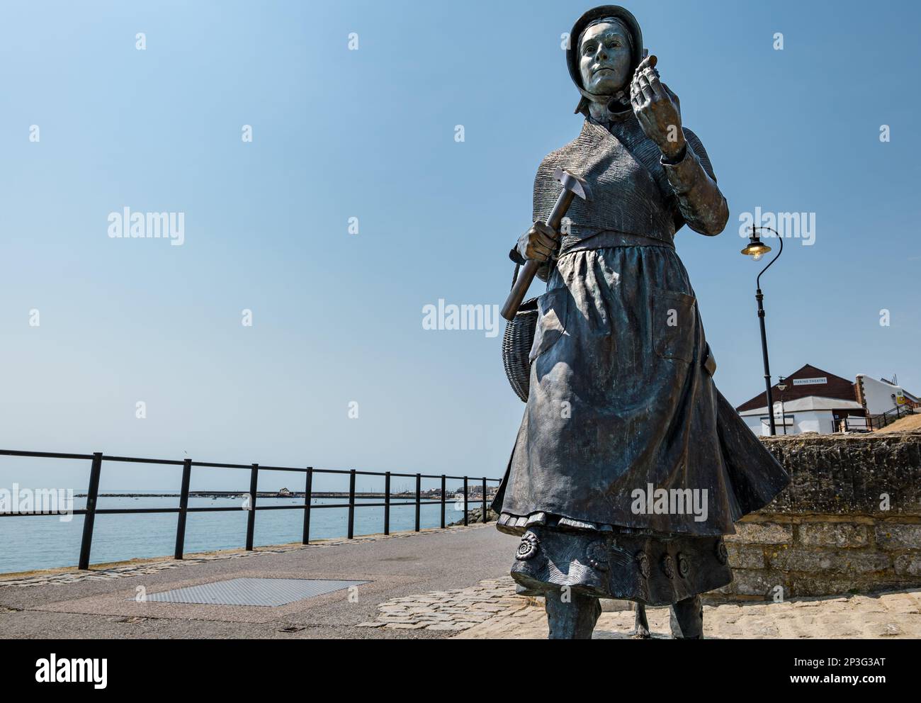 Bronze sculpture of geologist Mary Anning holding a fossil on Jurassic