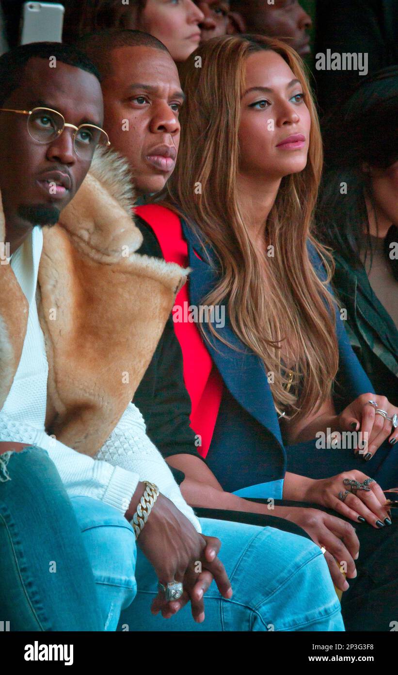 Sean Combs, from left, Jay Z, and Beyonce watch as Kanye West's Yeezy Boost  shoe line for Adidas is shown during Fashion Week in New York on Thursday,  Feb. 12, 2015. (AP