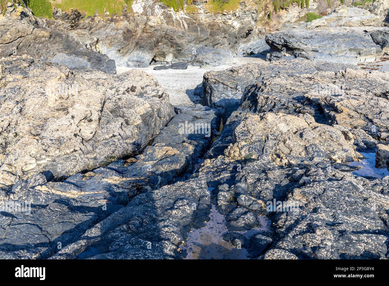 Cart wheel tracks worn in the rocks carrying contraband ashore at  Prussia Cove?  . Base of infamous 18th century smuggler John Carter Stock Photo