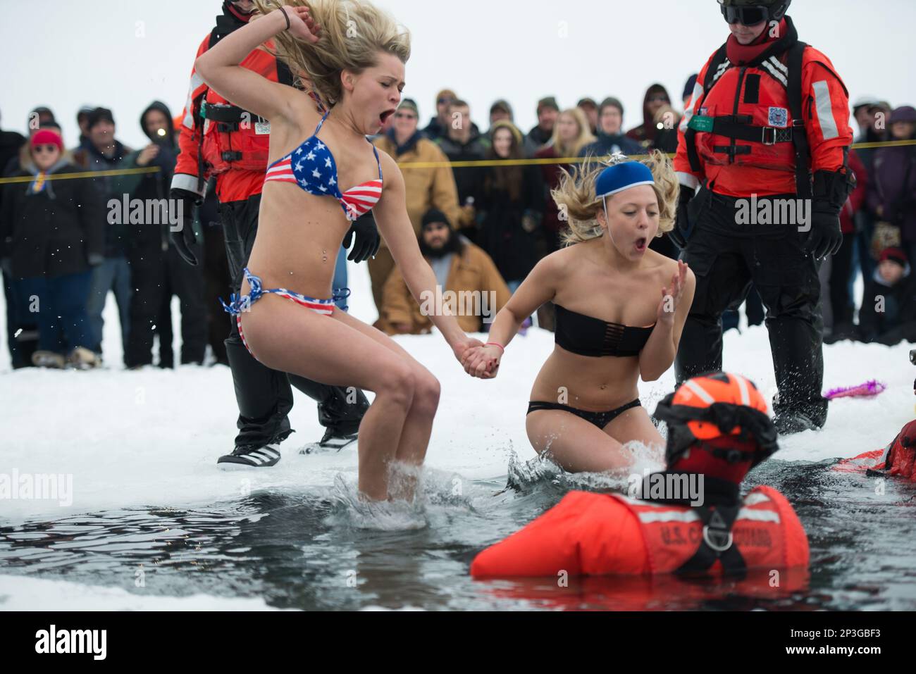 In this photo taken Saturday, Feb. 7, 2015, two women jump through a