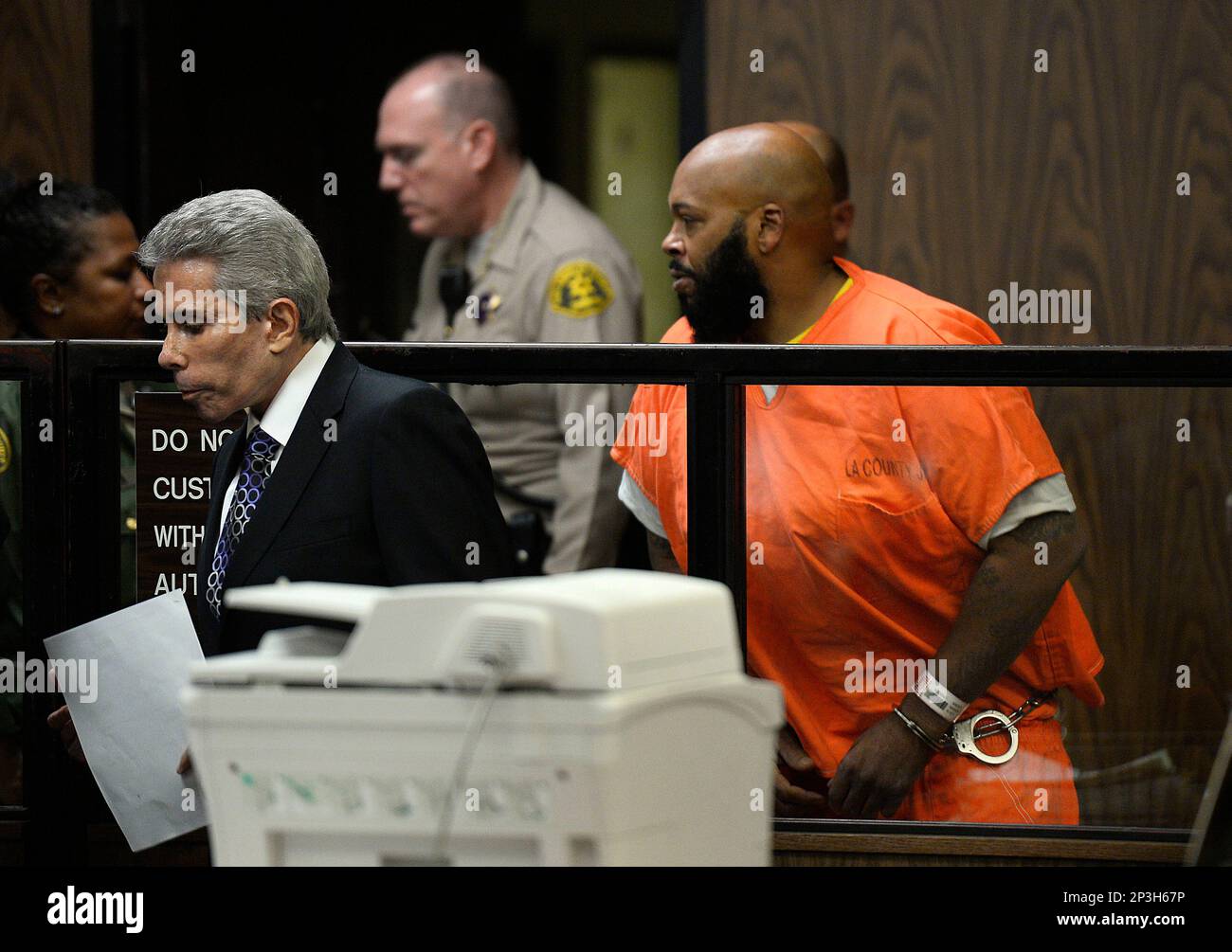 Death Row Records founder Suge Knight, right, leaves a courtroom with