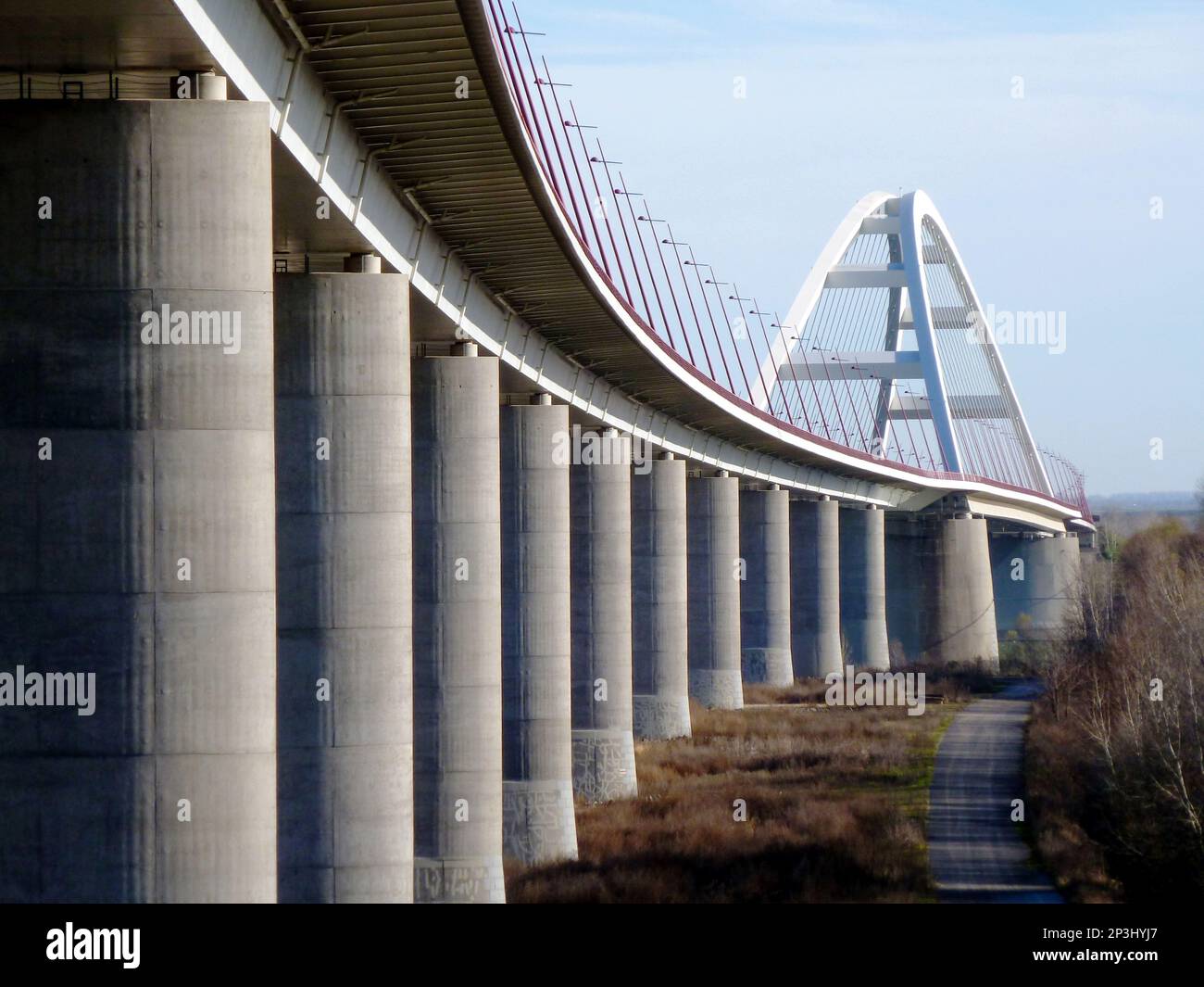 white basket handle arch design steel suspension bridge. modern red