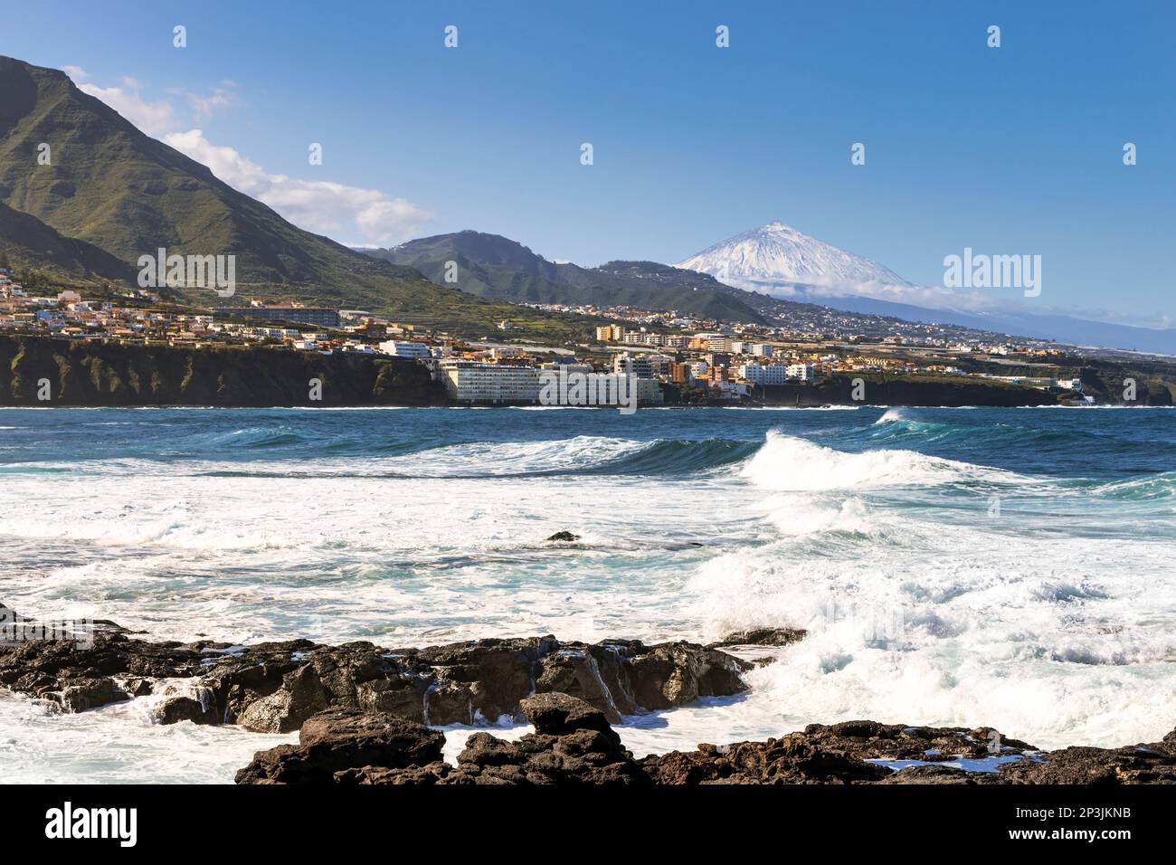 Coast of Punta del Hidalgo in Tenerife with the coastal town of Bajamar and Mount Teide in the background. Stock Photo