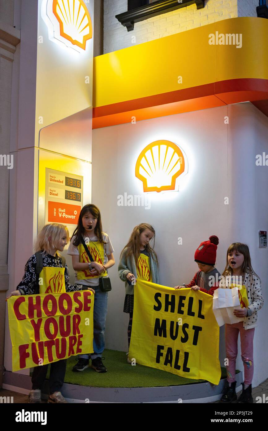 London, England, UK 05/03/2023 Children hold a protest against Shell and British Airways sponsorship at Kidzania indoor kids city, in the Westfield Shopping Centre. The called on the centre manager to stop their collaboration with fossil fuel companies like Shell and BA as they are both outdated job opportunities. The centre proceeded to call the police to attend the protest despite it involving children. Credit: Denise Laura Baker/Alamy Live News Stock Photo