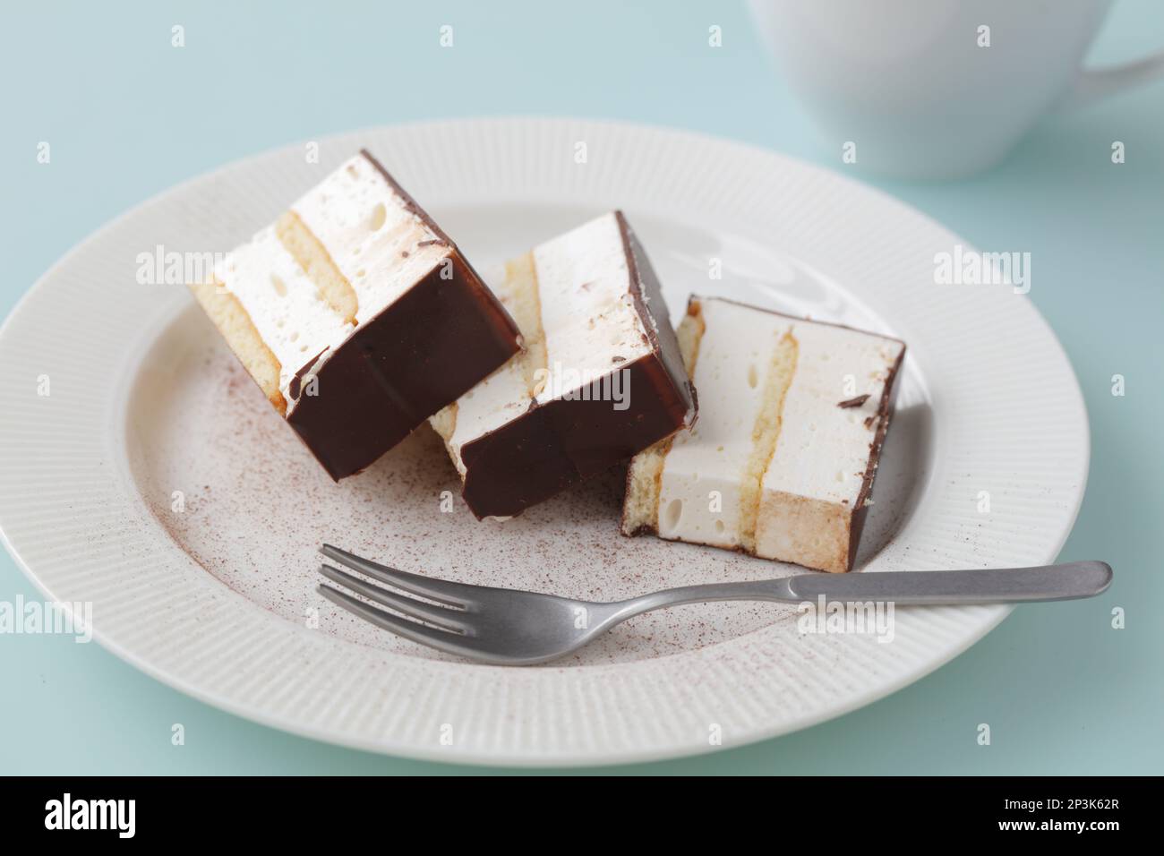 Three slices of souffle cake covered by chocolate on a table Stock Photo