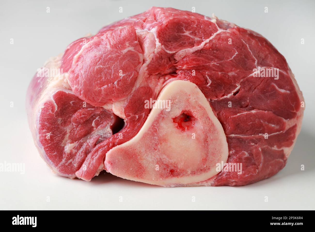 Raw cross-cut of veal shank on a rustic table Stock Photo
