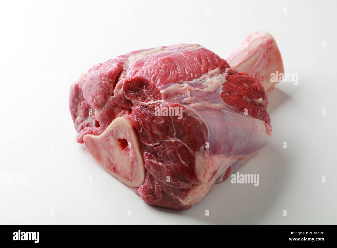 Raw veal shank on a bone on a white table in butchers shop Stock Photo