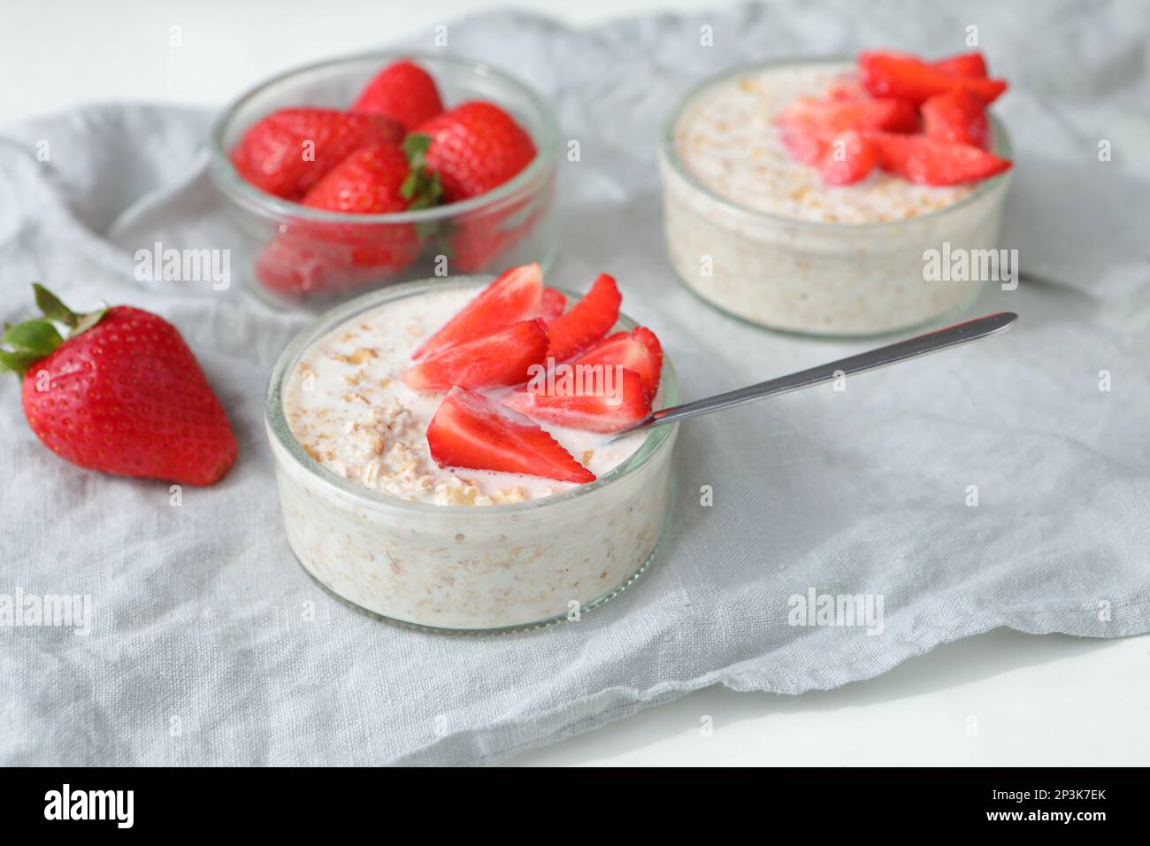 Healthy breakfast: two portions of muesli with milk  and sliced fresh strawberries Stock Photo