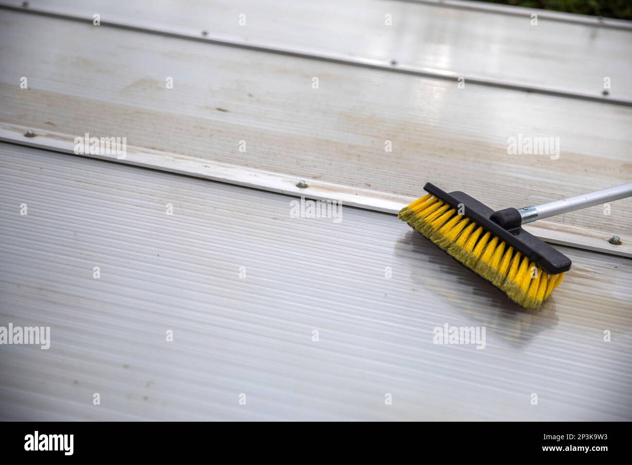 Washing the patio pergola roof cover made of aluminum. removing the