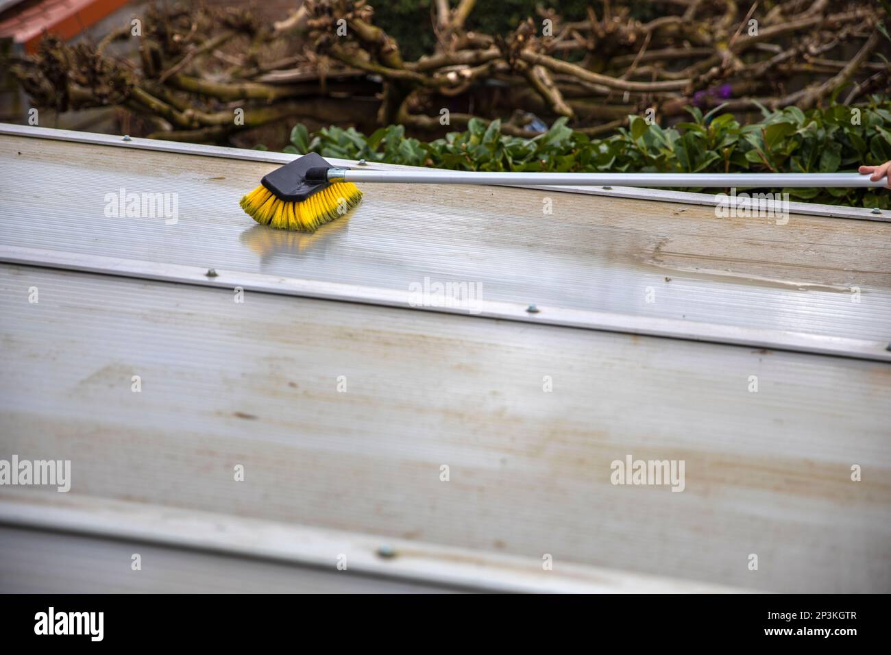 Washing the patio pergola roof cover made of aluminum. removing the