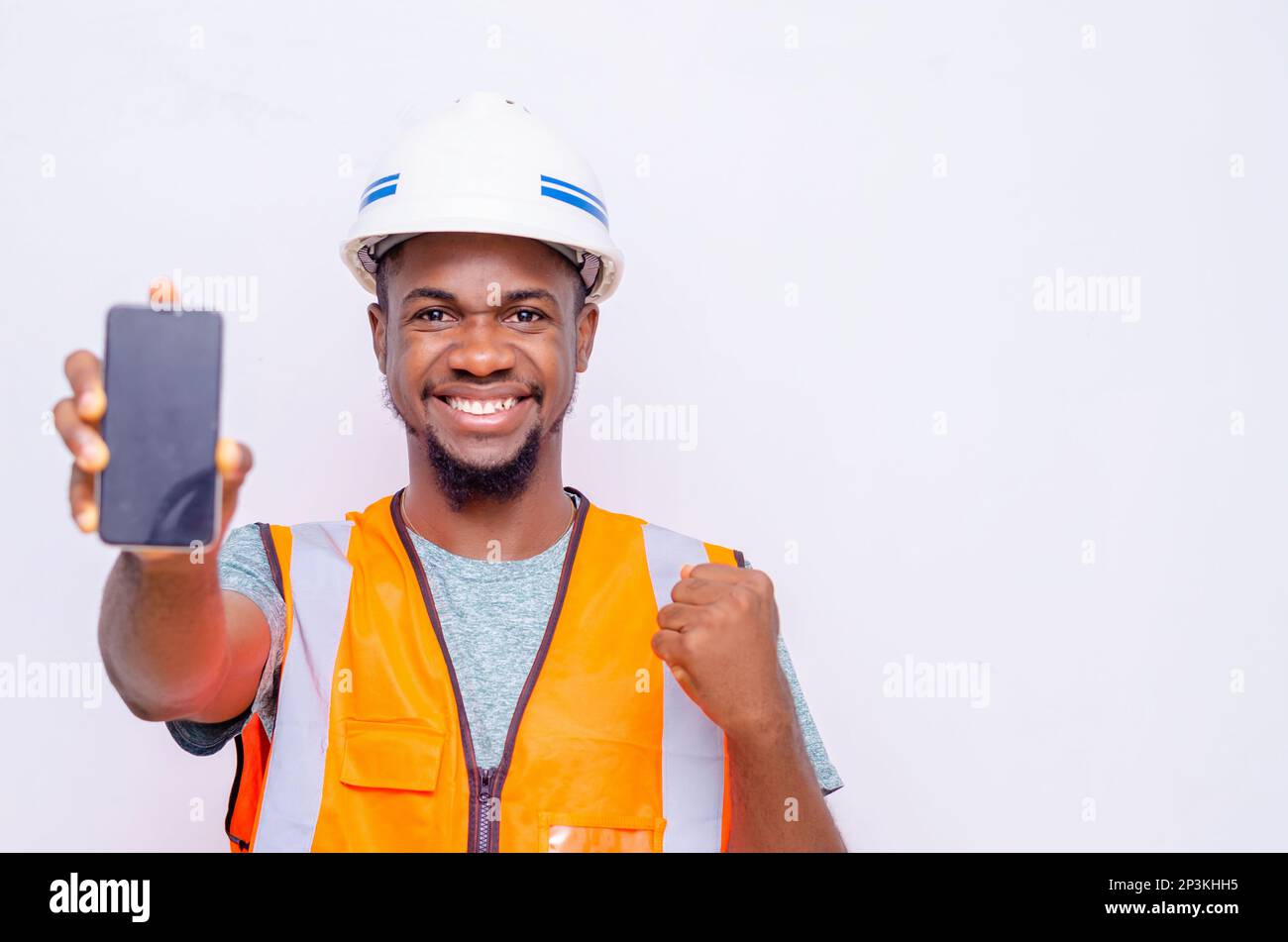 Architects holding a smartphone with isolated blank screen. Stock Photo