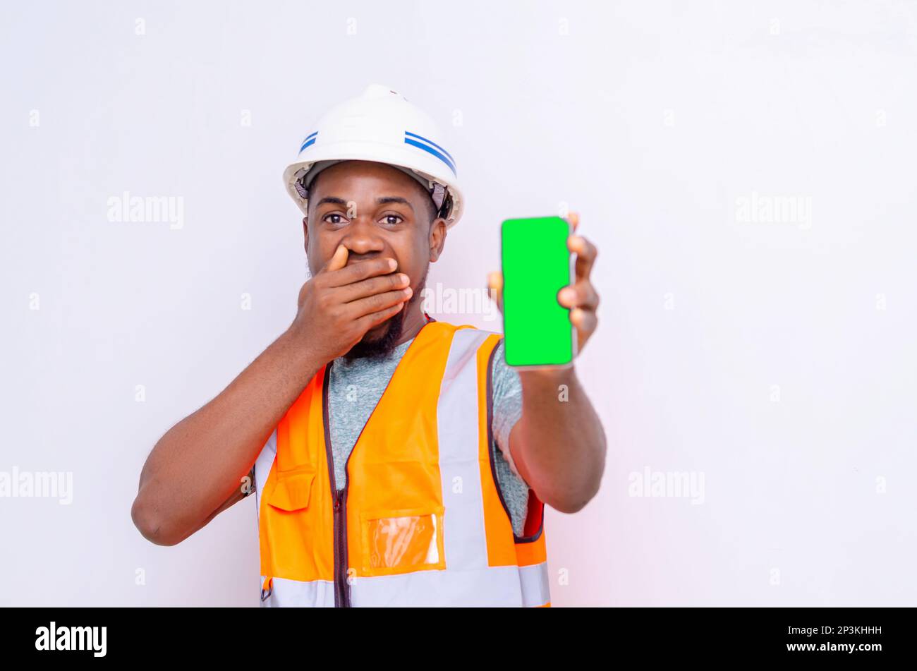 Architects holding a smartphone with isolated blank screen. Stock Photo