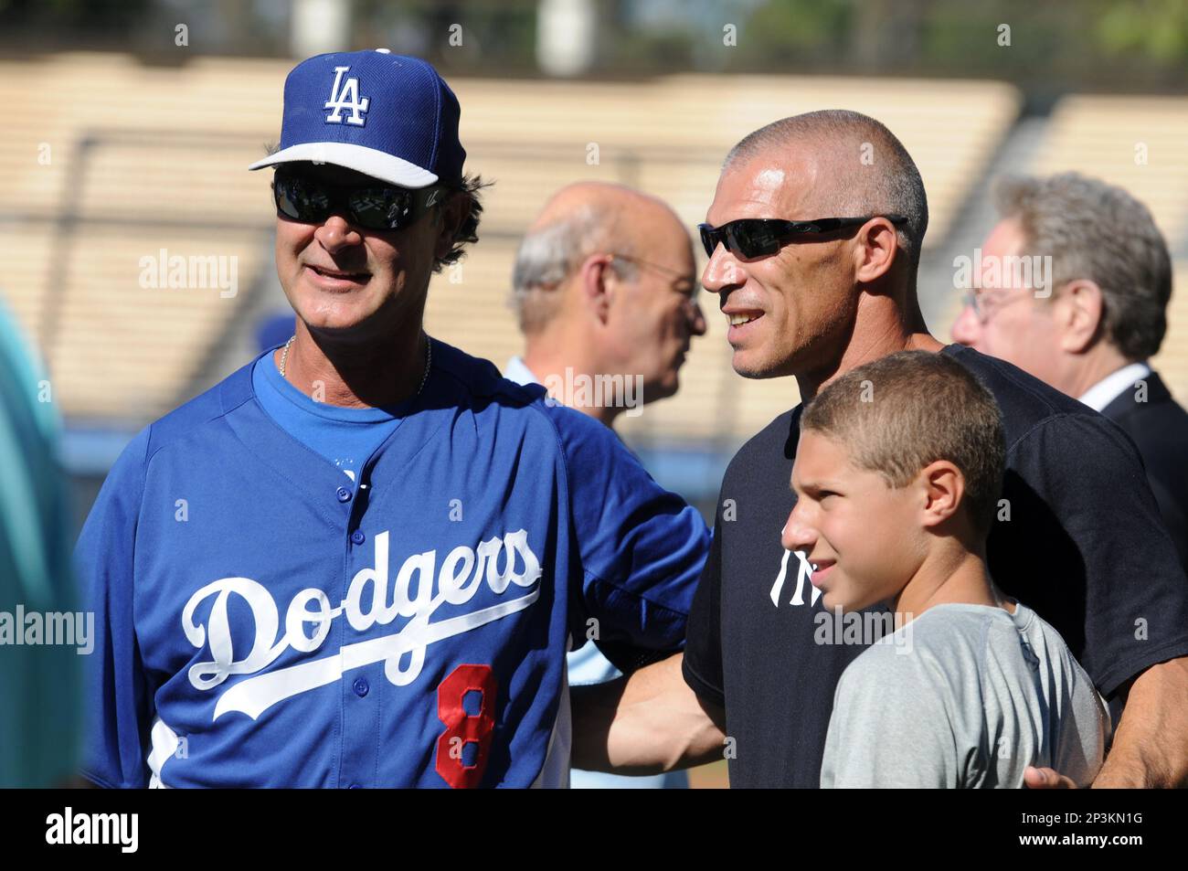 30 July 2013: Yankees manager Joe Girardi and his son Dante Girardi take a  photo with Dodgers manager Don Mattingly prior a Major League Baseball  interleague game between the New York Yankees