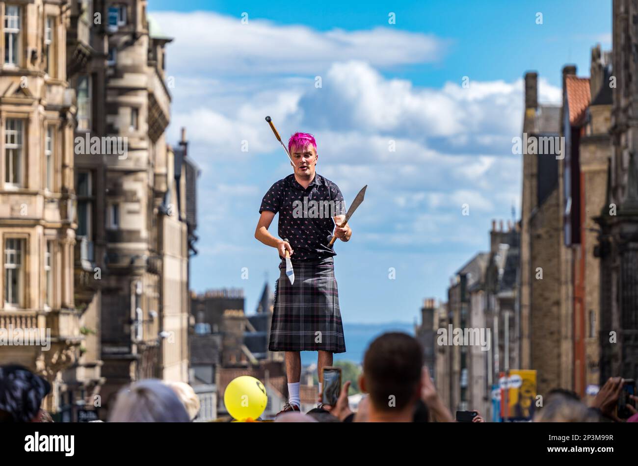 Street entertainer juggler performing during festival, Royal Mile, Edinburgh, Scotland, UK Stock Photo