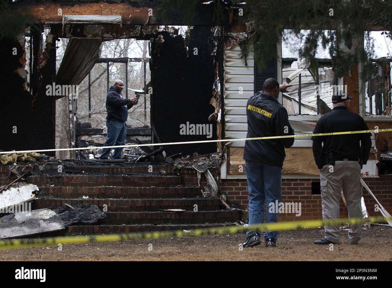 Granville County authorities survey the damage to the burned the home