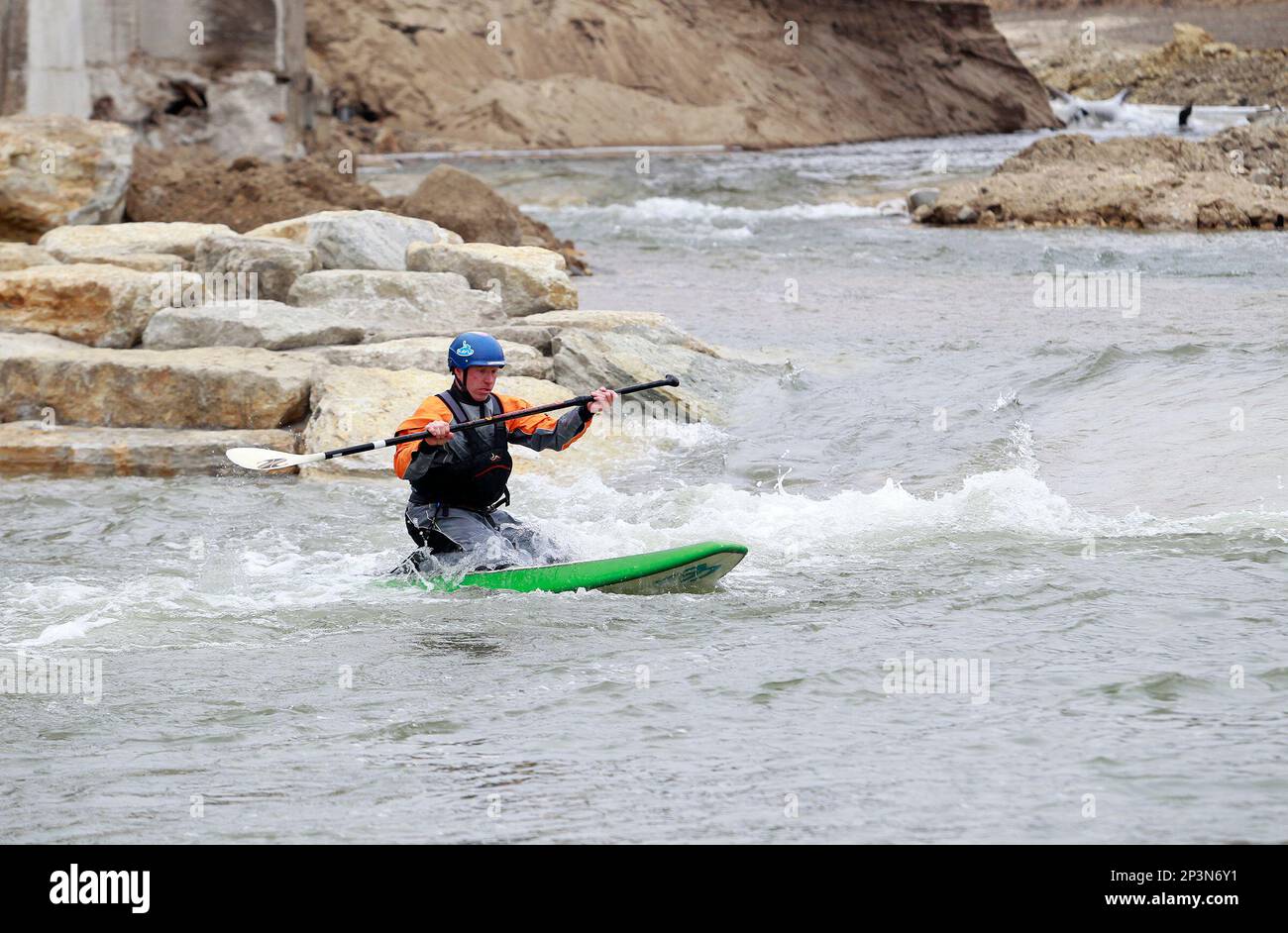 In this Friday, Dec. 19, 2014 photo, Ty Graham uses his paddleboard to