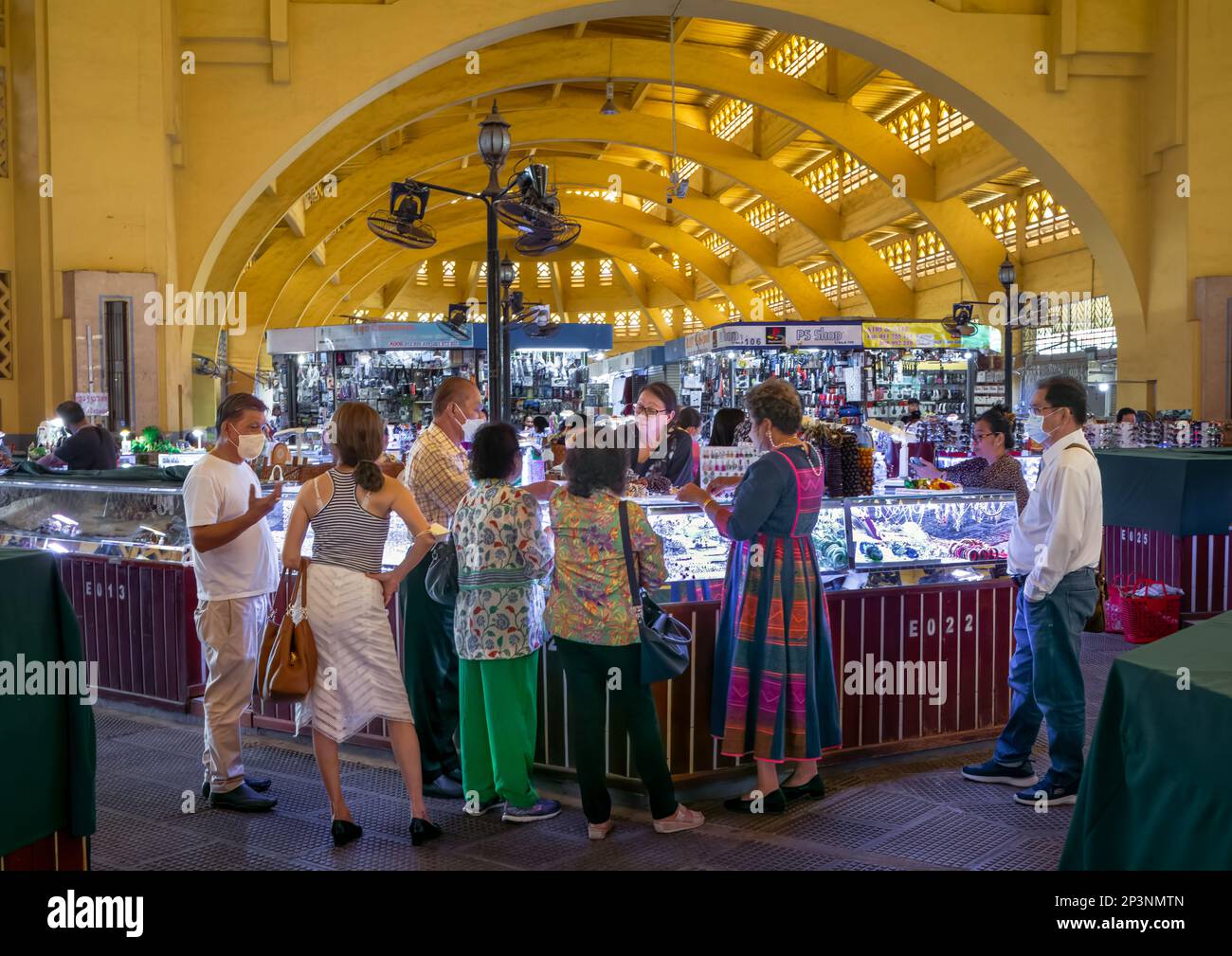 A group of middle-aged people shop at a jewellry stall inside the art deco Central Market in Phnom Penh, Cambodia. Stock Photo