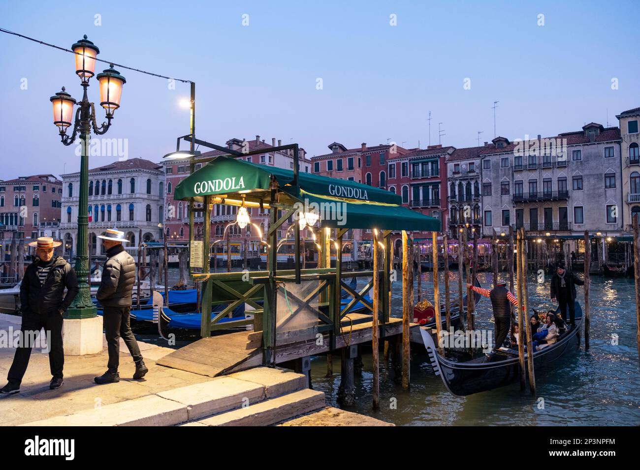 Gondolas tied up at a Gondola Station, on the Grand Canal at San Silvestro, Rialto, Venice, Italy Stock Photo