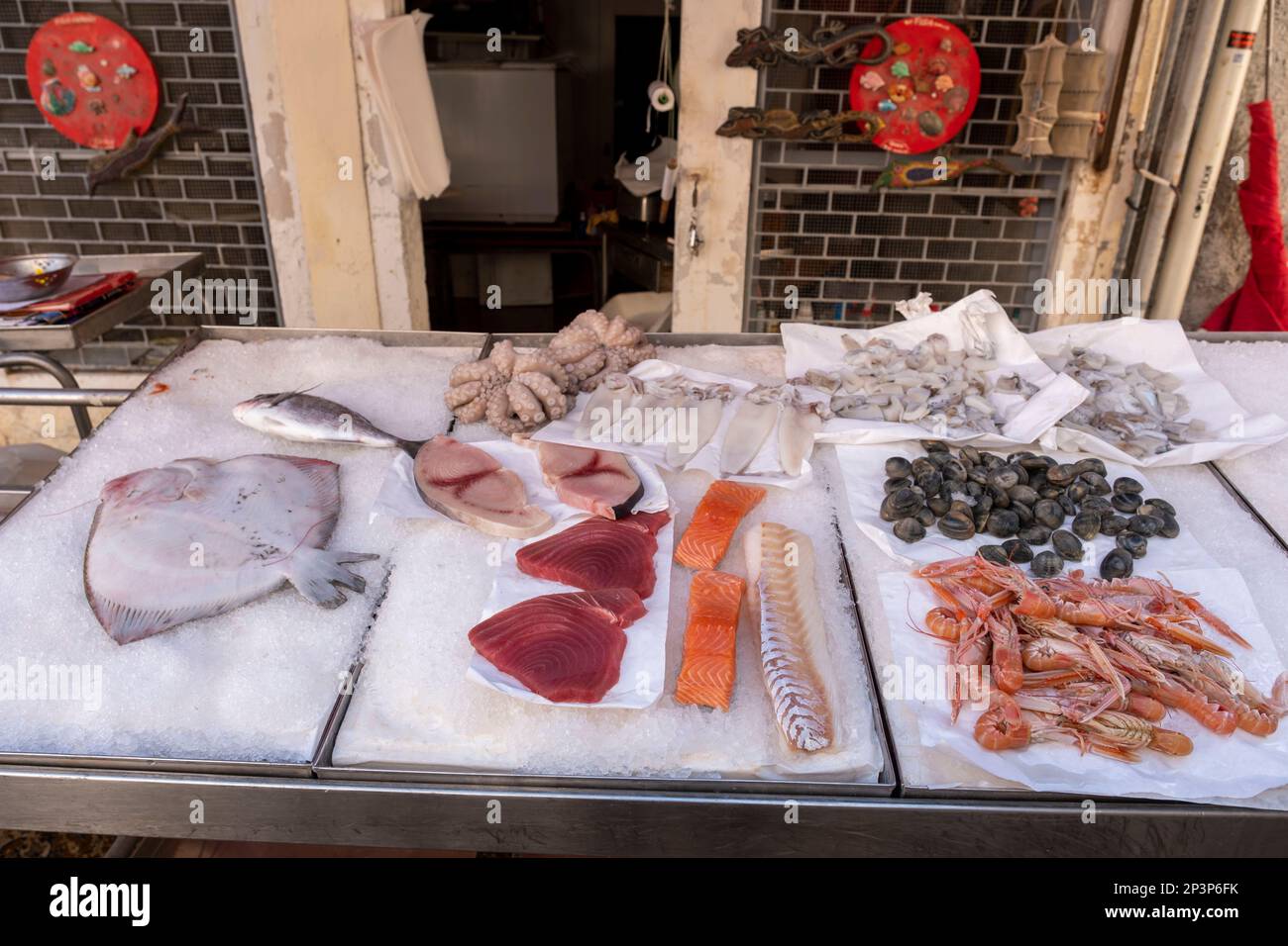 Fish vender with his display of fresh fish laid out for sale, Venice, Italy Stock Photo