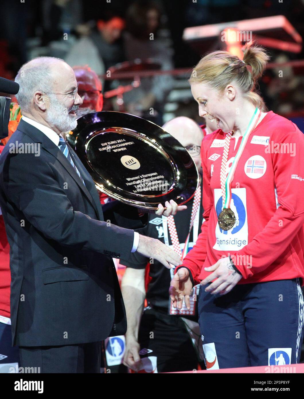 President of the European Handball Federation (EHF) Jean Brihault, left,  hands over the trophy to Karoline Dyhre Breivang, member of the golden  medalist Norwegian team during the women's handball European Championship  award