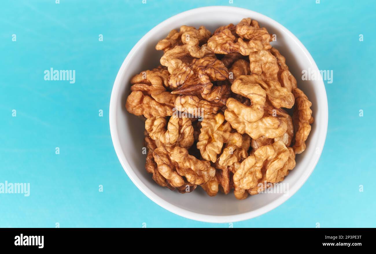 Organic walnuts in a bowl, selective focus. Stock Photo